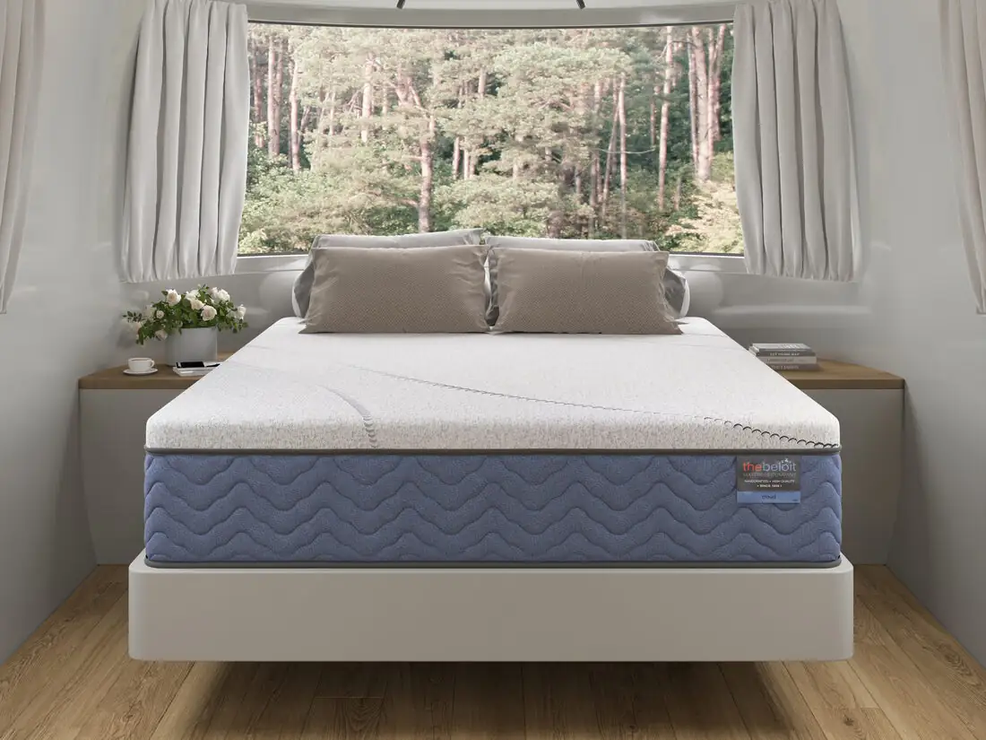A Beloit mattress in an Airstream by a forest window